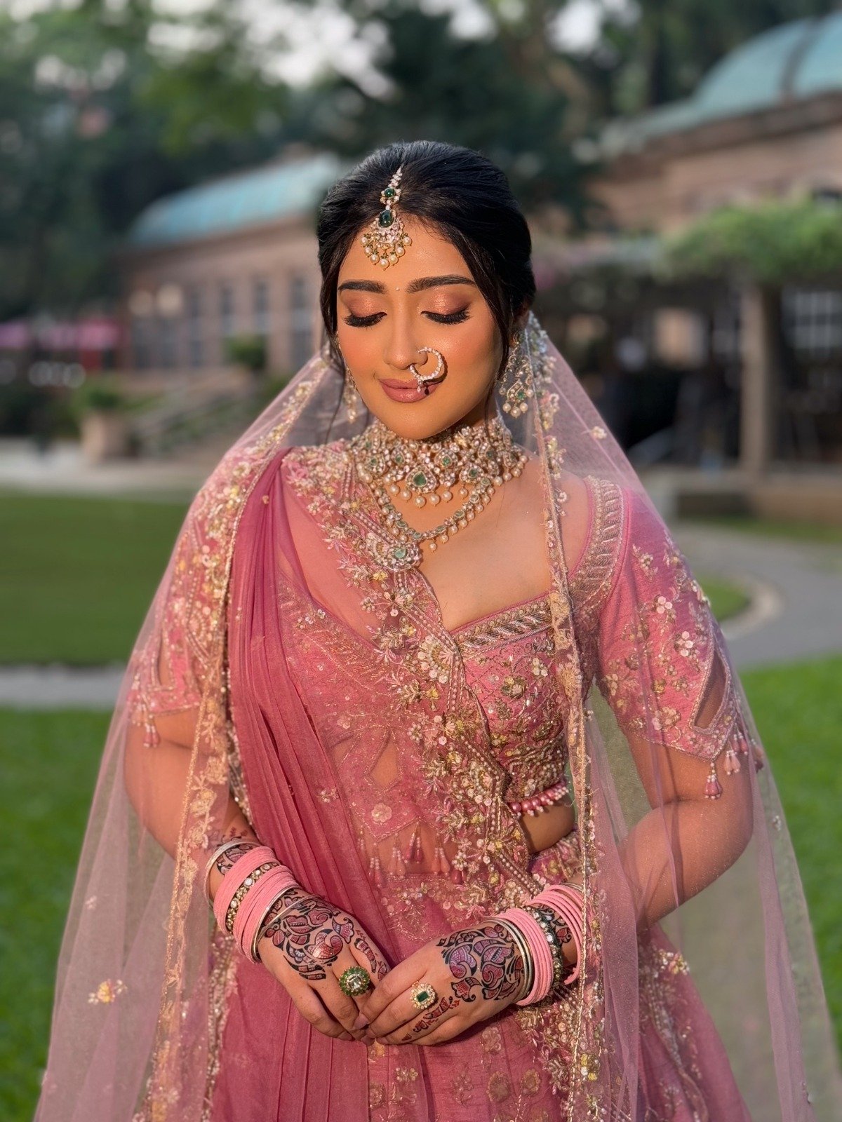 Golden hour bride with a pink dupatta drape, bridal makeup by Tejaswini