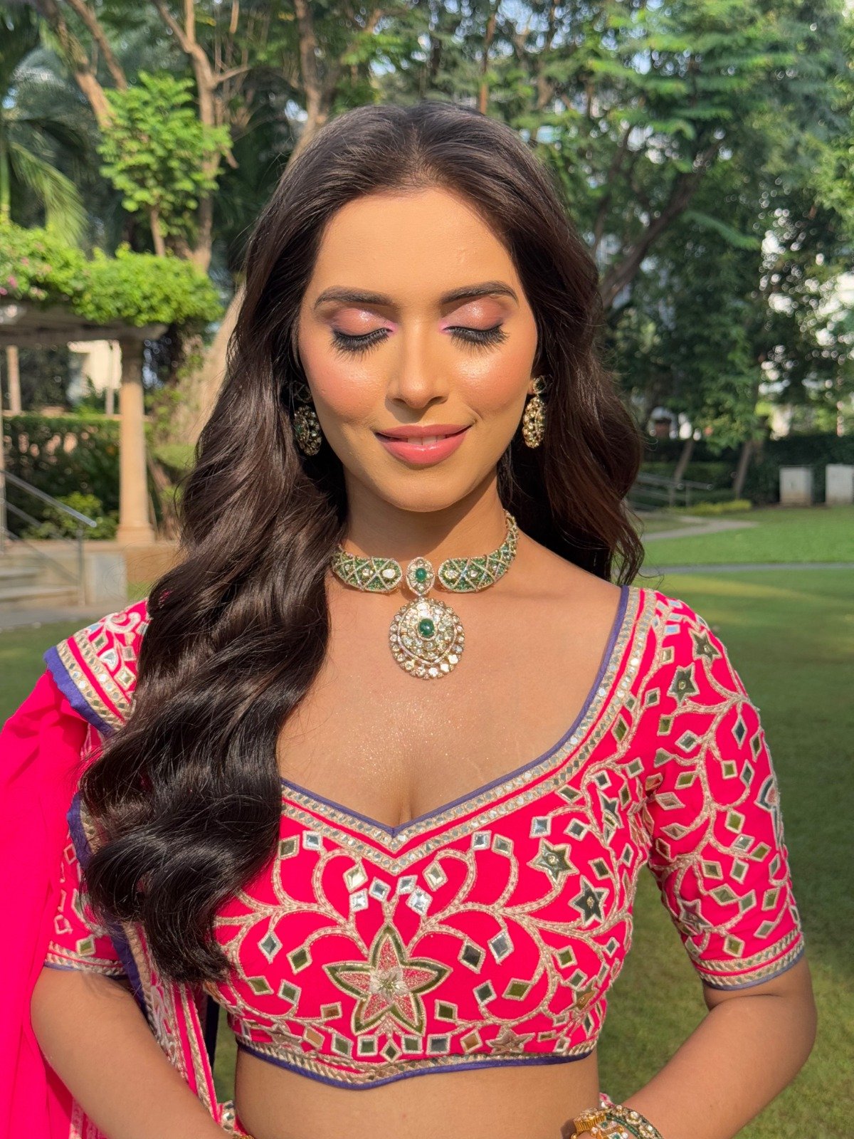 Reception-style party makeup with a pink lehenga and open hair in Pune by Tejaswini