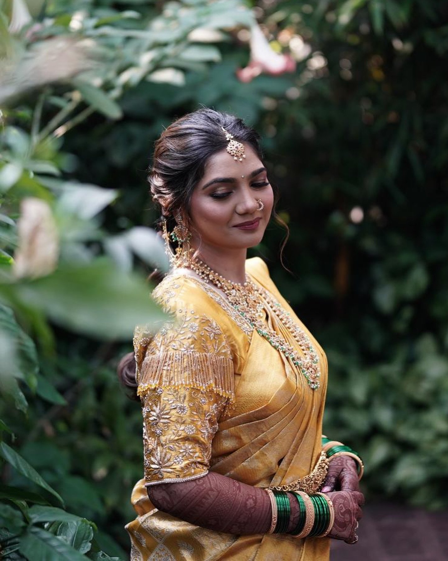 Haldi ceremony bride in a gold saree with daylight makeup by Tejaswini