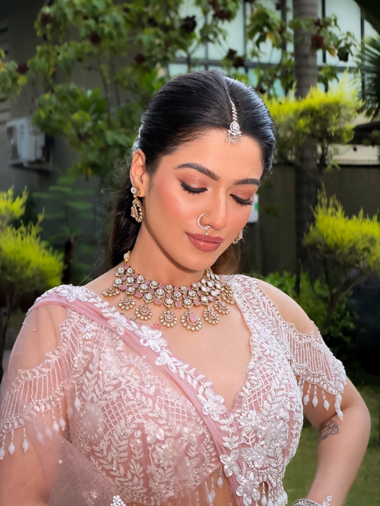 Bride in a lehenga with clean, settled bridal makeup by Tejaswini