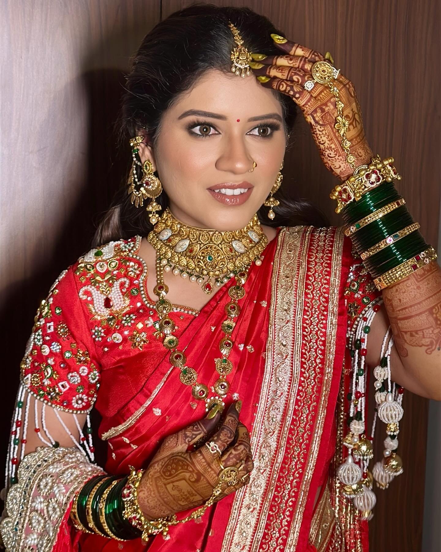 Marathi bride in a ceremonial red Nauvari saree with traditional Nath