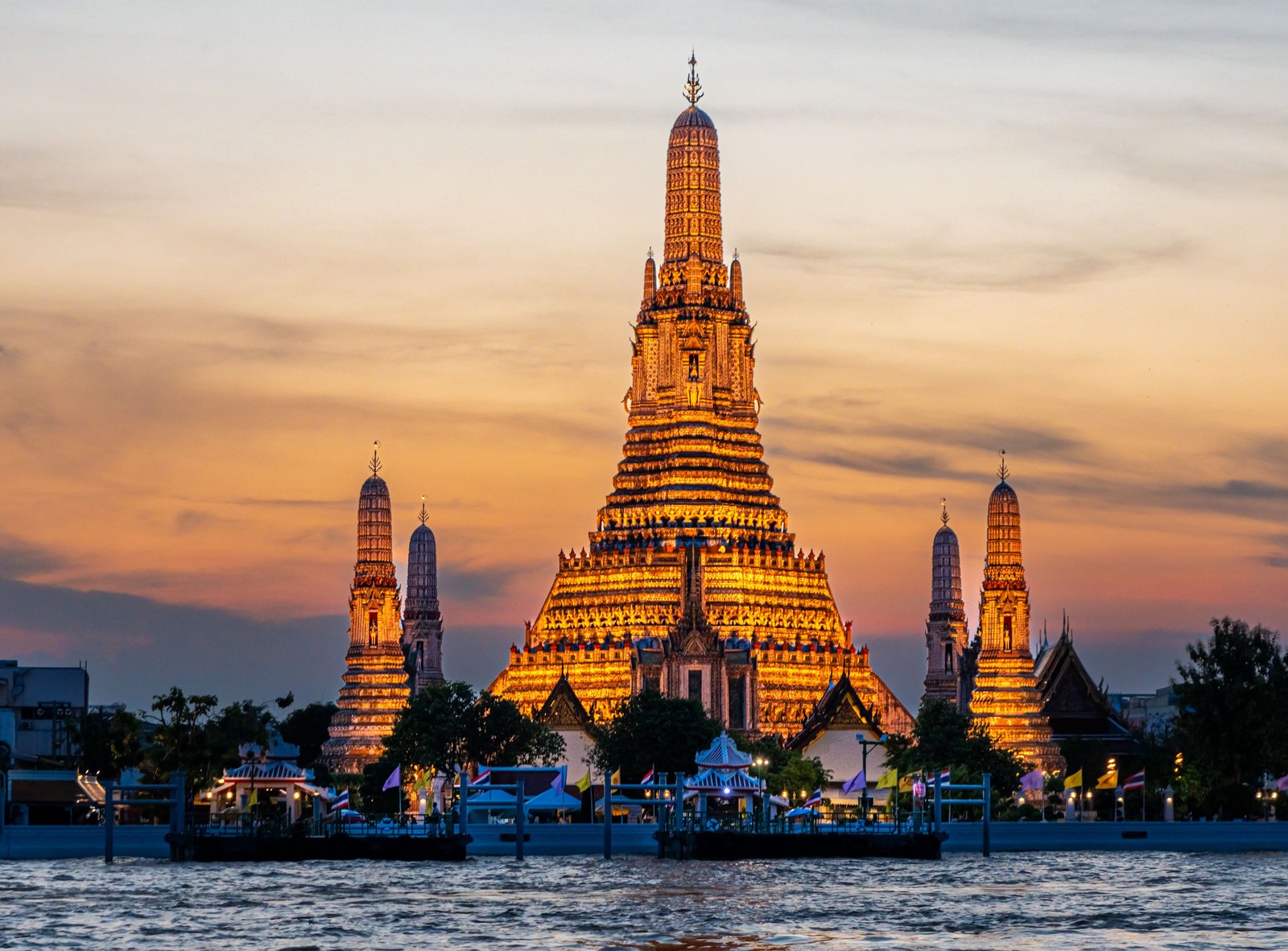Wat Arun temple at sunset along the Chao Phraya river, Bangkok