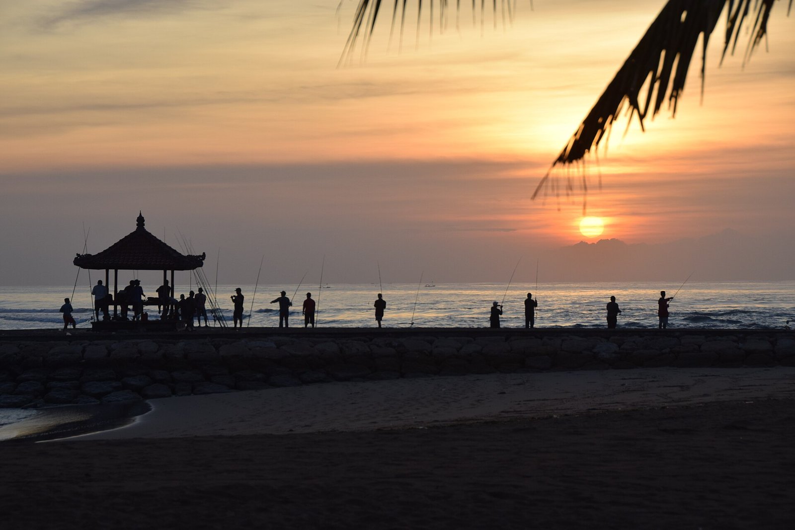 Fishermen at sunrise on the beach at Nusa Dua, Bali