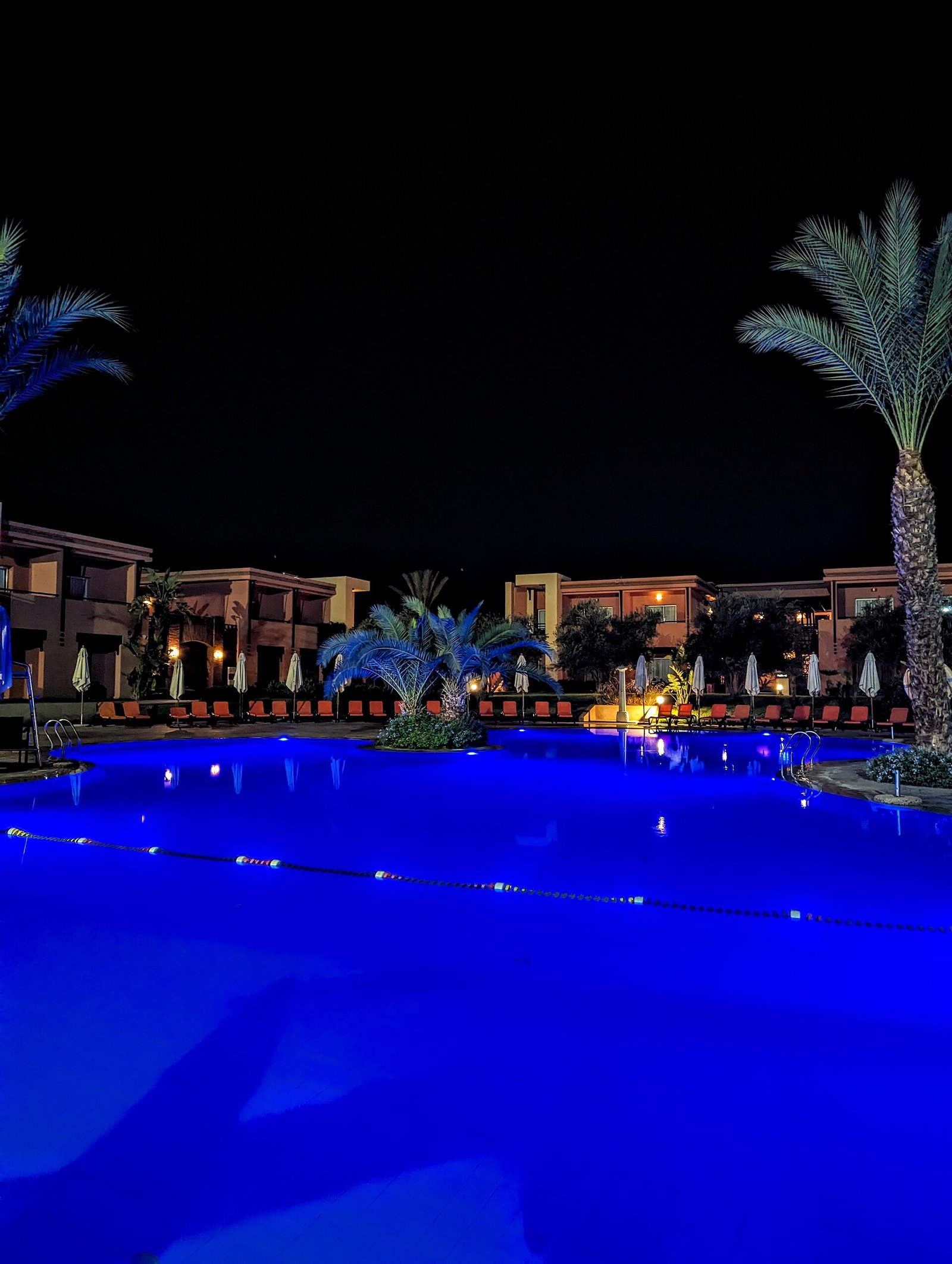 A Marrakech resort pool by night