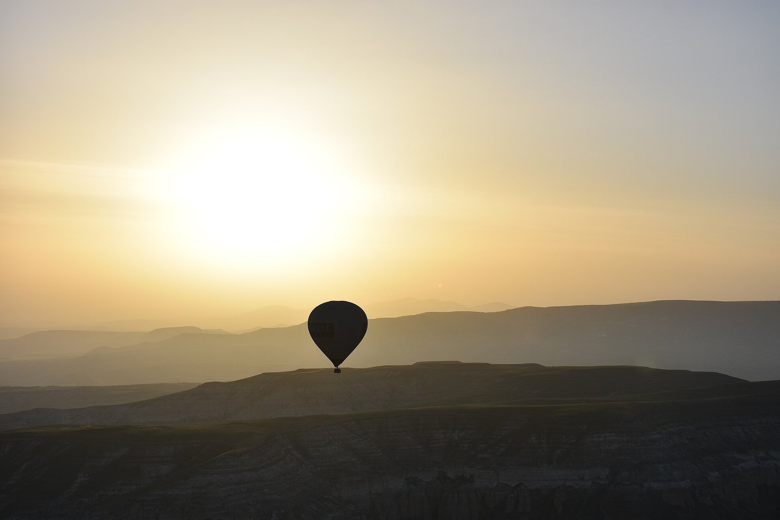 A hot air balloon at sunrise over Cappadocia